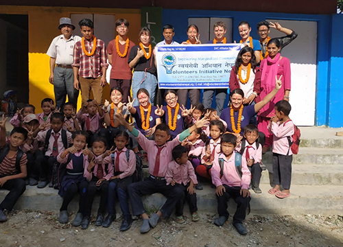 Volunteers in front of a school 